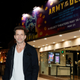 Director Zack Snyder stands in front of a billboard for his 2021 Netflix movie Army of the Dead.